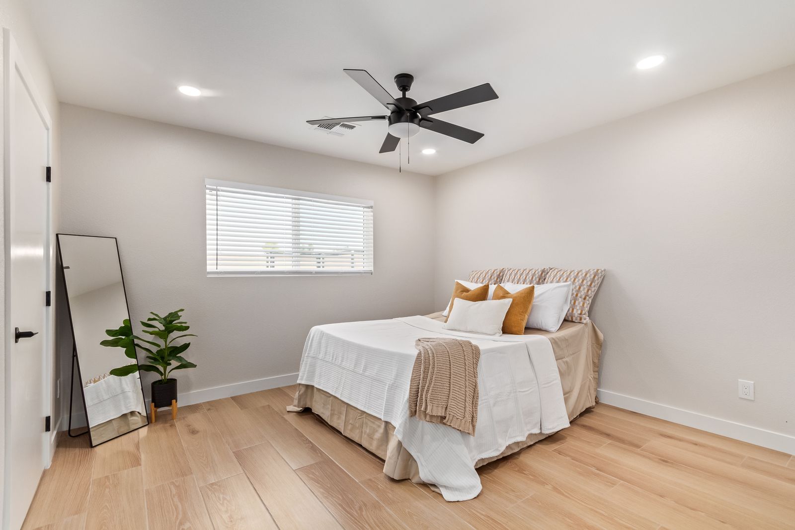 Bedroom with light wood-look plank flooring