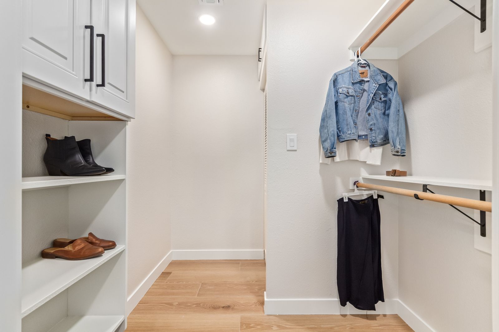 Walk-in closet with wood-look plank flooring