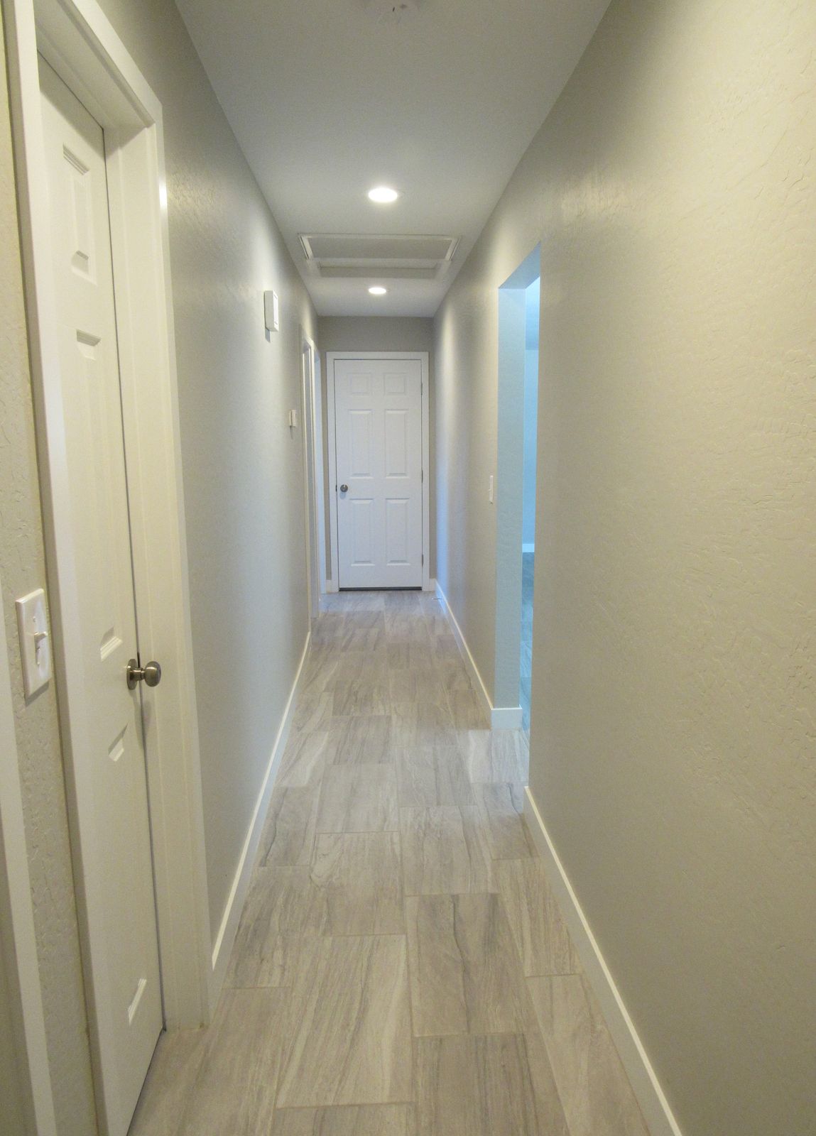 Long hallway with plank flooring