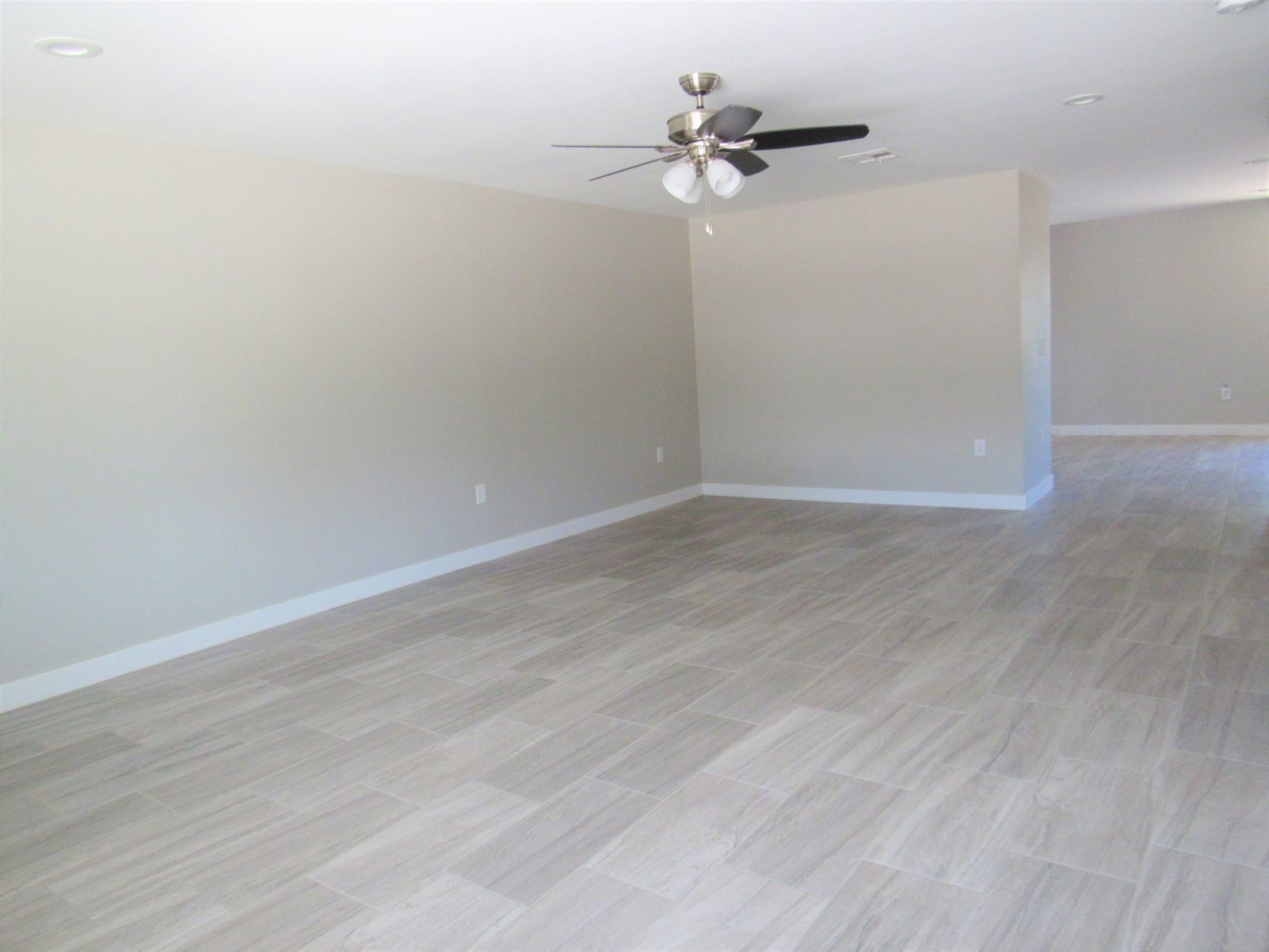 Open living room with gray plank flooring