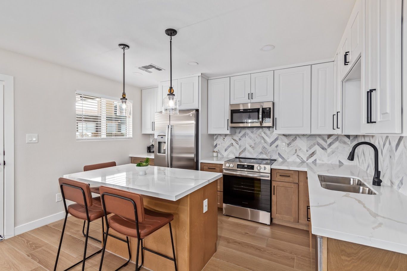 Kitchen with quartz island and wood-look tile floor