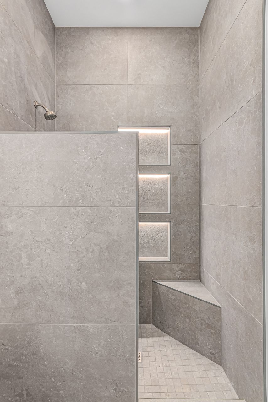 Gray stone-look shower with stacked niches