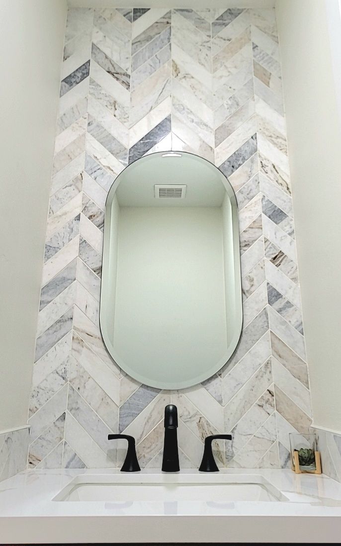Herringbone stone feature wall behind a bathroom vanity