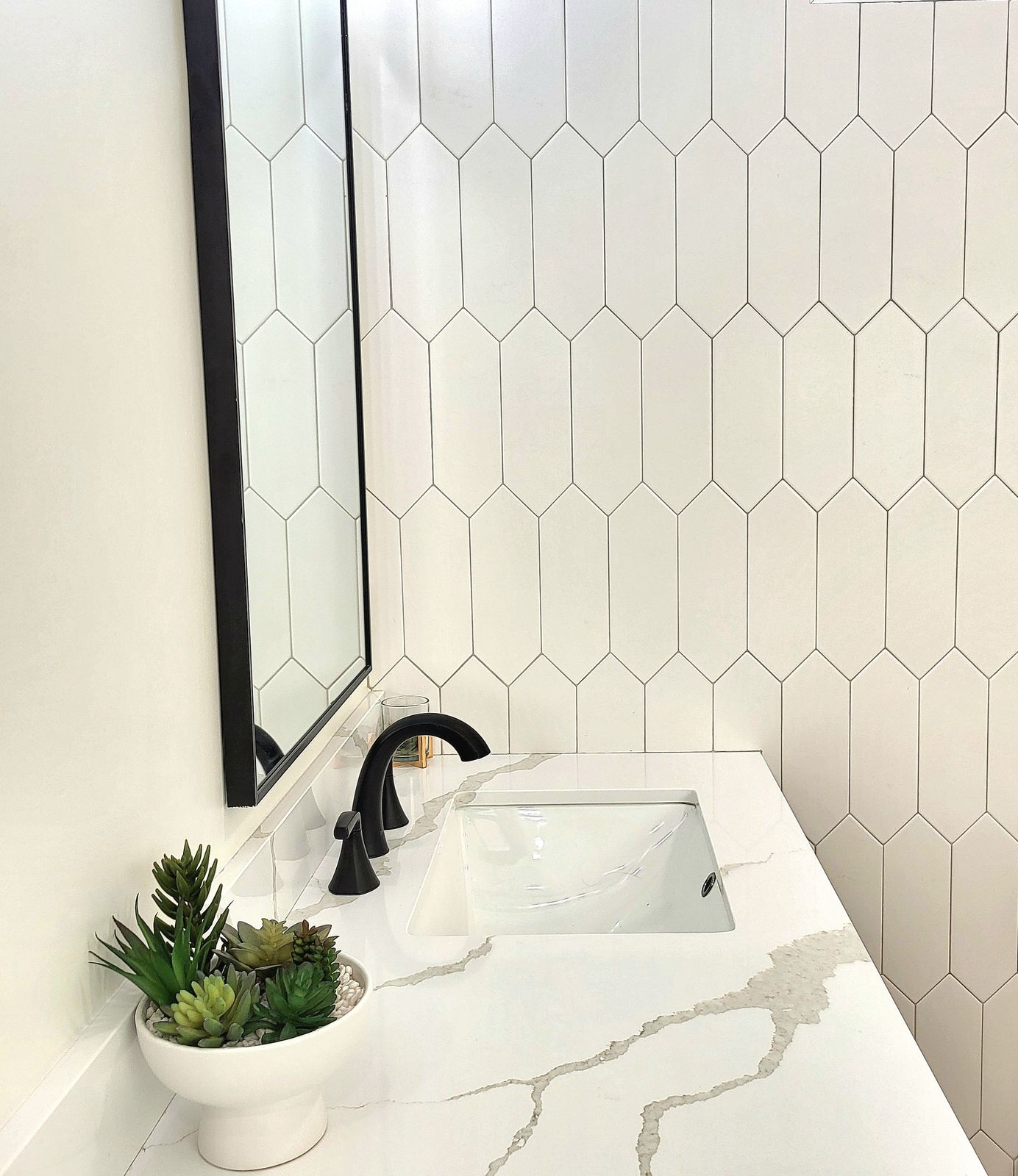 Quartz vanity top with white picket tile backsplash